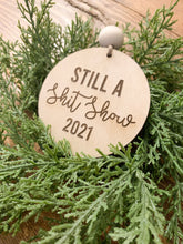 Load image into Gallery viewer, Wood Engraved 2021 Still a Sh*t Show Ornament
